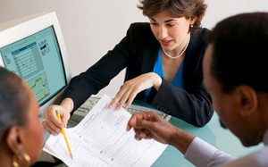 woman helping couple plan their finances