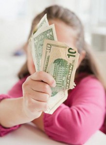 child clutching money