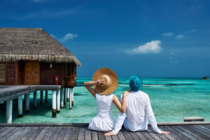 Couple on a beach jetty at Maldives