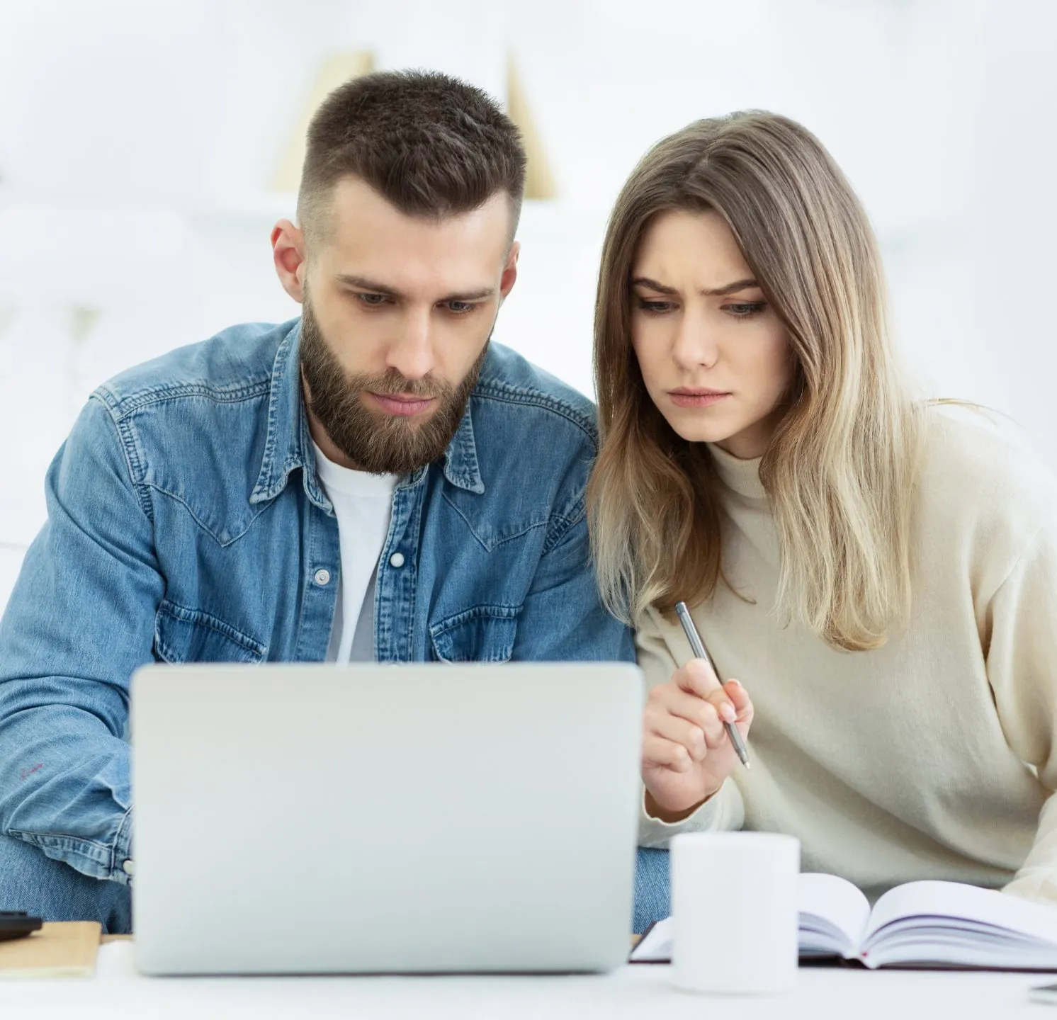 Young couple planning family budget with laptop