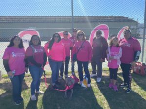 Group of people together, wearing pink