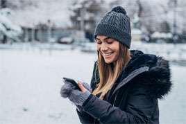 lady dressed in winter clothes, on phone