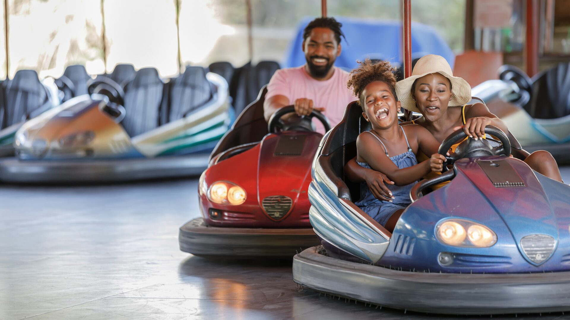 family playing in bumper cars